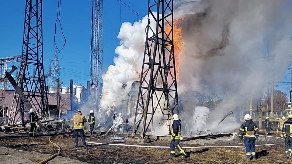 Firefighters try to put out a fire at a Ukrainian substation after a Russian attack