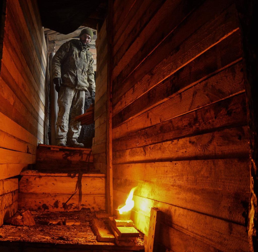 Stuck: a Ukrainian soldier in Donetsk Oblast at a bunker entrance