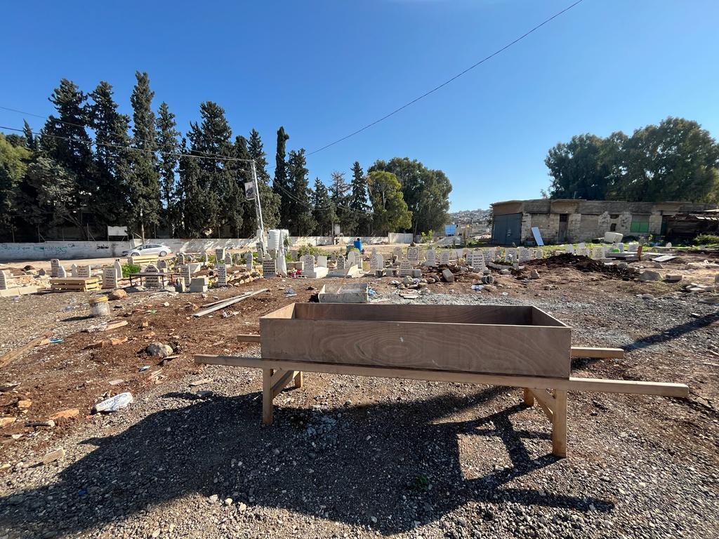 A stretcher used to transport the remains which are buried in a shroud, without a coffin, in the Jenin cemetery, January 7, 2024.
