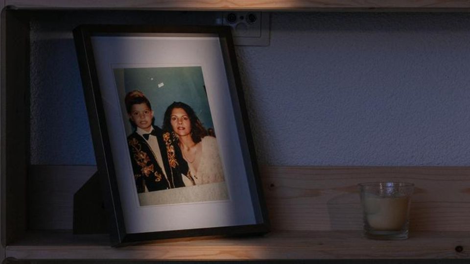 Shelf in Sfaxis's apartment with family pictures