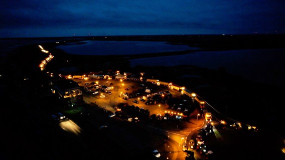 A drone shot of a gathering of farmers with tractors at night.  © West Coast News Photo: West Coast News
