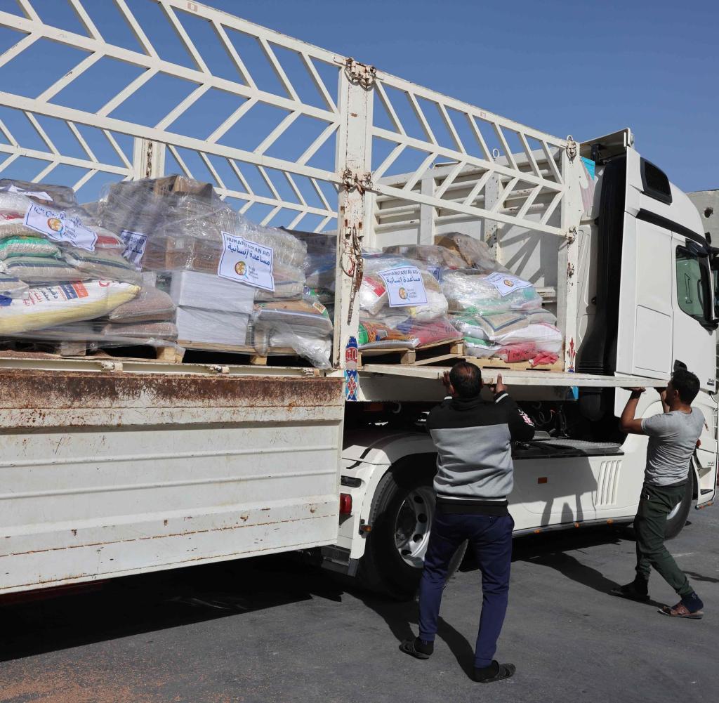 A truck with relief supplies is loaded at the Gaza-Egypt border