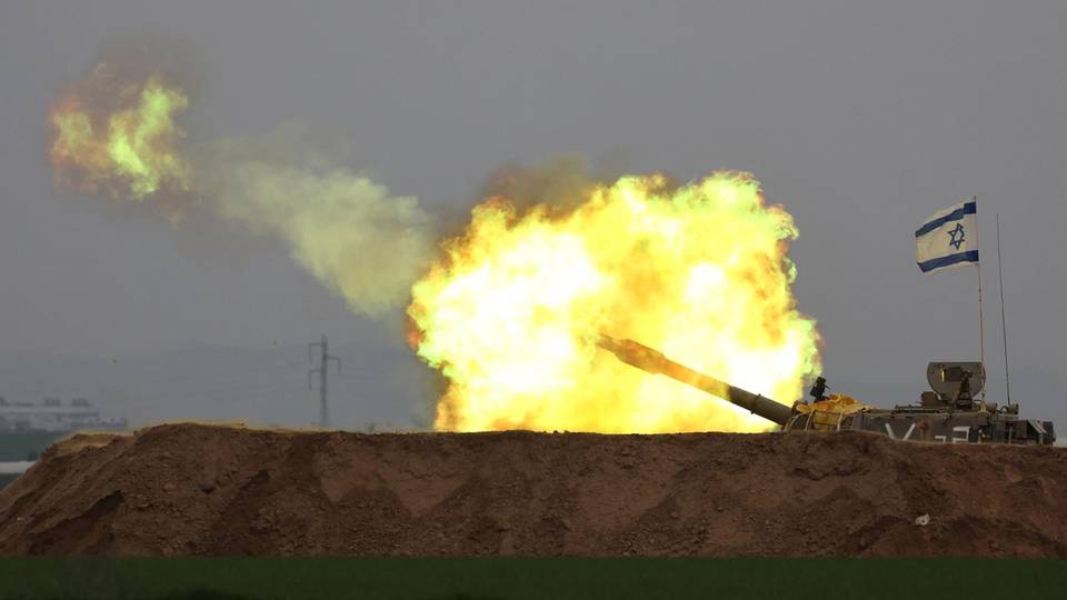 A tank fires towards the Gaza Strip