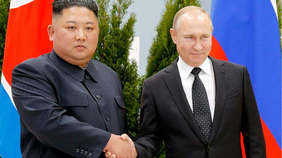 Putin and Kim shake hands