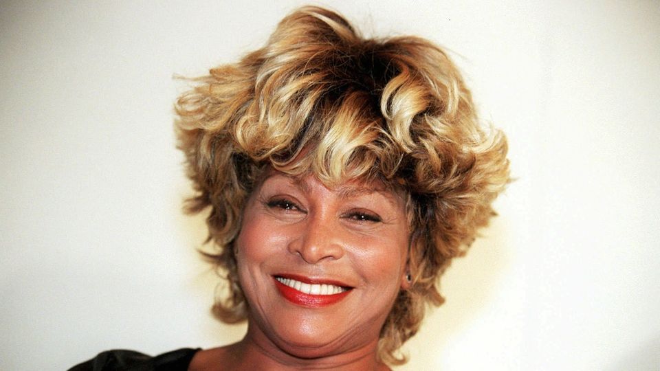 Tina Turner laughs into the camera.