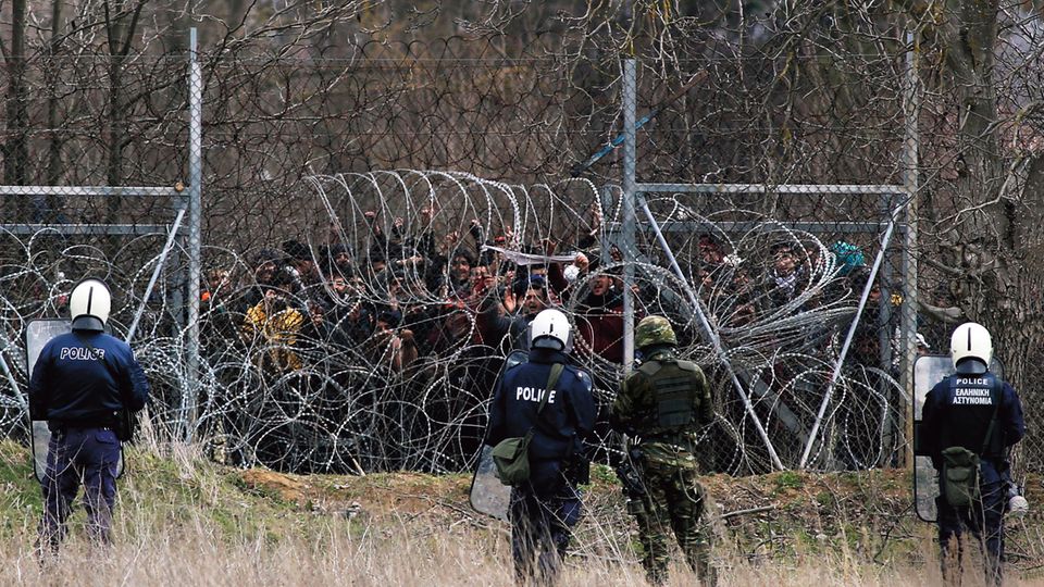Refugees behind barbed wire at the Turkish-Greek border