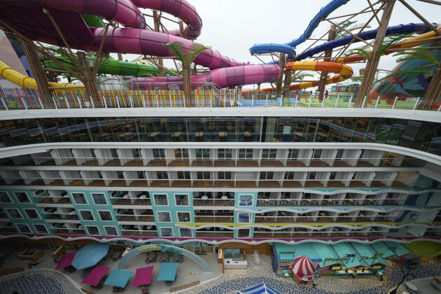   Water slides on a deck overlooking floors of rooms aboard the 