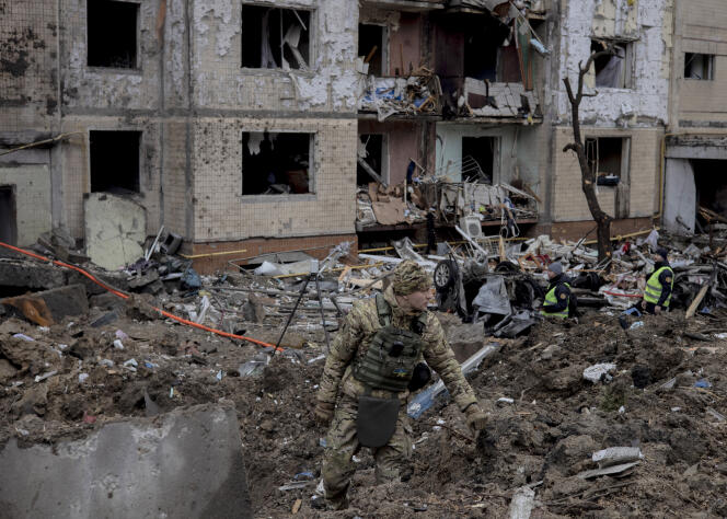 A Ukrainian soldier near a residential building after a Russian strike, in kyiv, January 2, 2024.