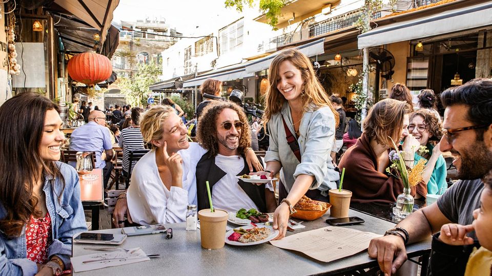 People having food at a restaurant table in Jaffa, Tel Aviv