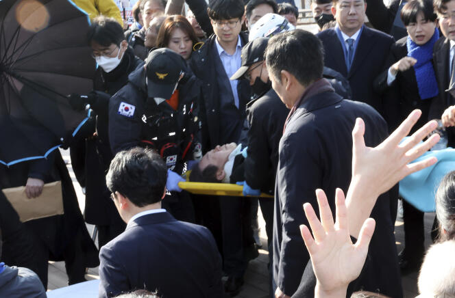 South Korean opposition leader Lee Jae-myung, on a stretcher, is carried by a rescue team in Busan, South Korea, after being stabbed in the neck, January 2, 2024.