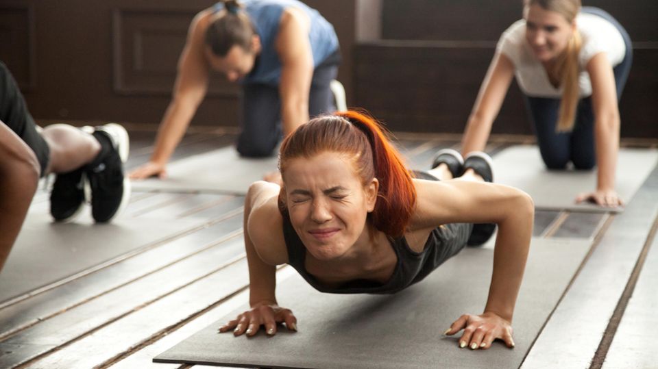 A group of women are doing planks
