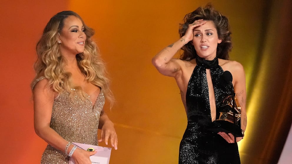 Mariah Carey (left) presented Miley Cyrus with a Grammy