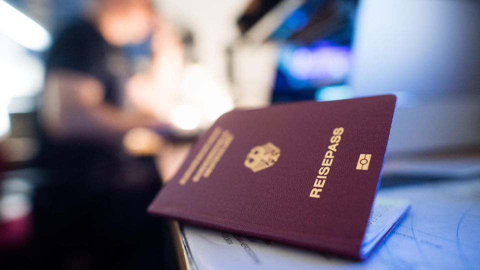 A German passport lies on a table