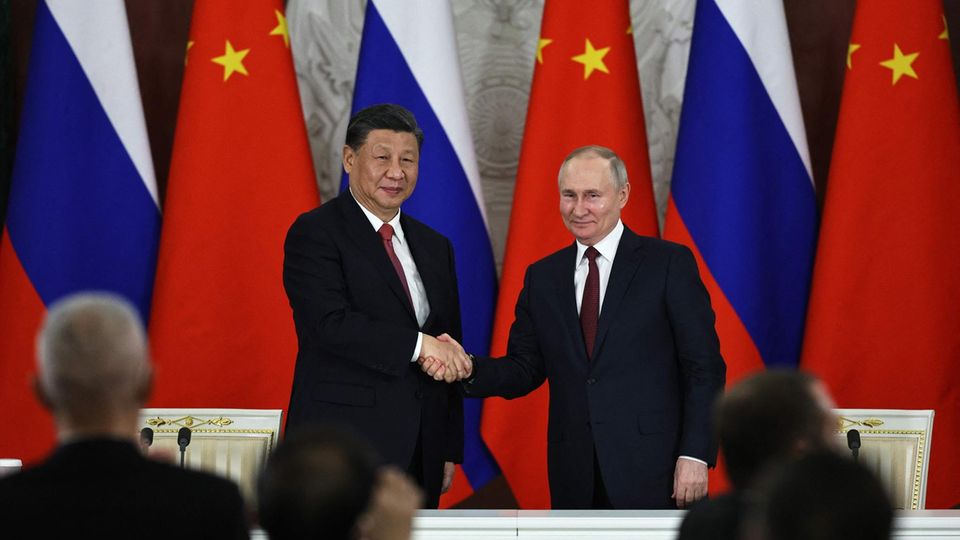 Xi Jinping and Vladimir Putin shake hands during a meeting in the Kremlin, March 21, 2023