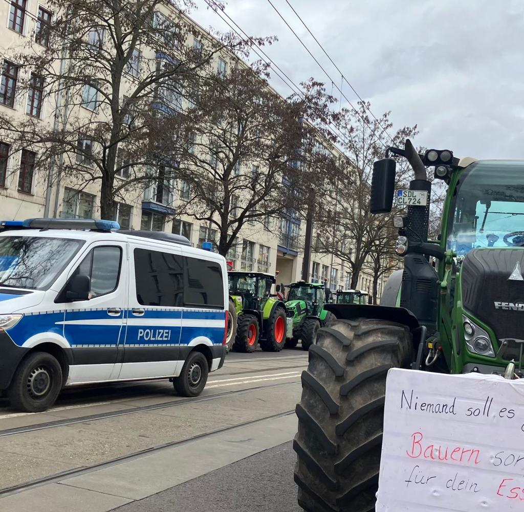 Tractors block a road on the edge of the event
