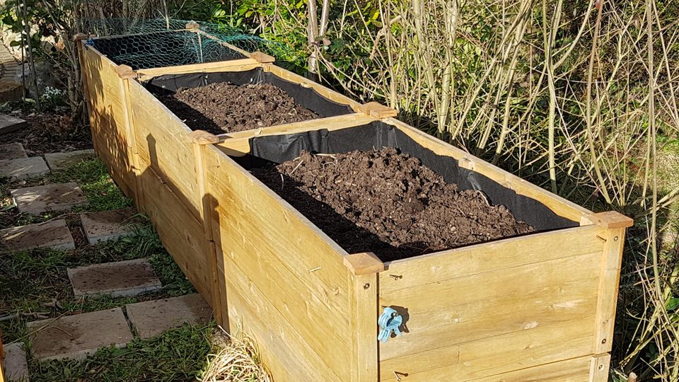 Paneled wooden boxes are ideal for raised beds