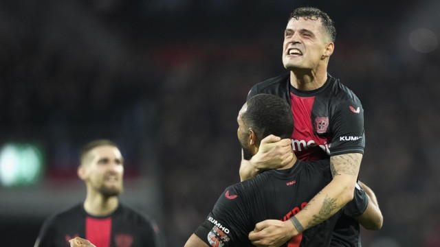 Bayer Leverkusen in the DFB Cup: Jonathan Tah and Granit Xhaka (above) celebrate after winning the quarter-finals.
