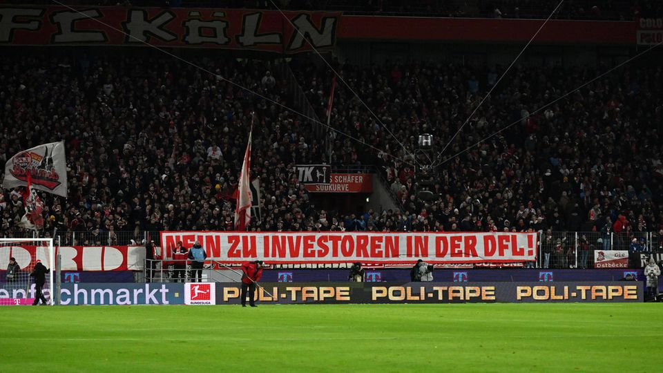 Fans of 1. FC Cologne protest against the entry of an investor into the DFL during the home game against Bayern Munich