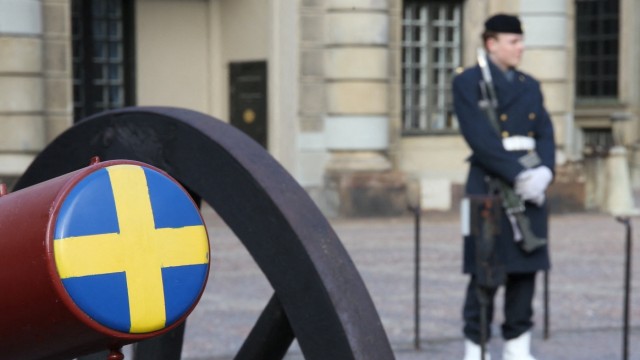 Defense policy: A Swedish soldier with an old cannon in front of the Royal Palace in Stockholm.