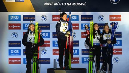 Justine Braisaz-Bouchet (2nd), Julia Simon (1st), Lou Jeanmonnot (3rd) and Sophie Chauveau (4th), from left to right, during the sprint podium in Nove Mesto, Friday February 9.  (MICHAL CIZEK / AFP)