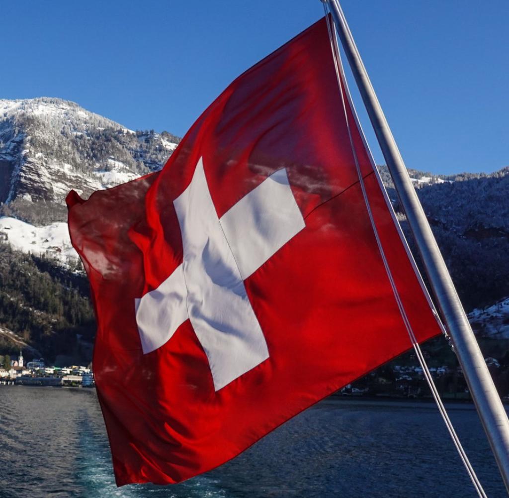 Swiss flag at the back on a boat sailing on lake Lucerne in Switzerland