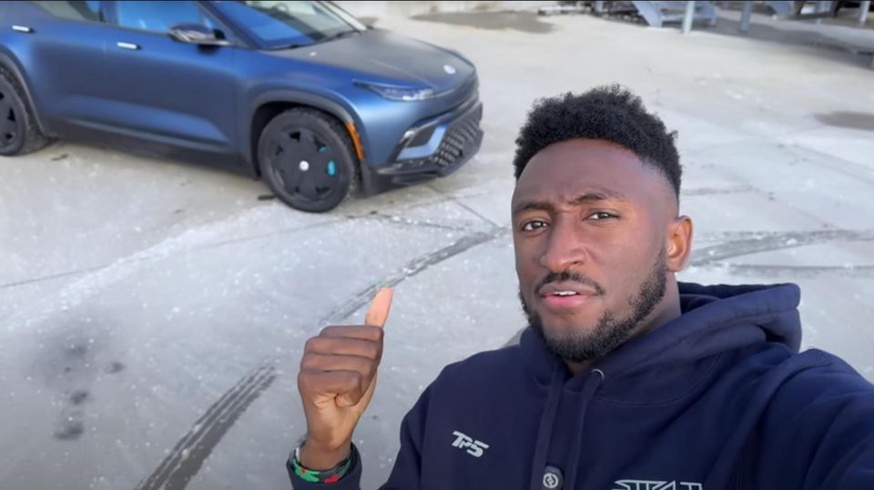 Marques Brownlee, aka MKBHD, stands in front of the Fisker Ocean SUV electric car