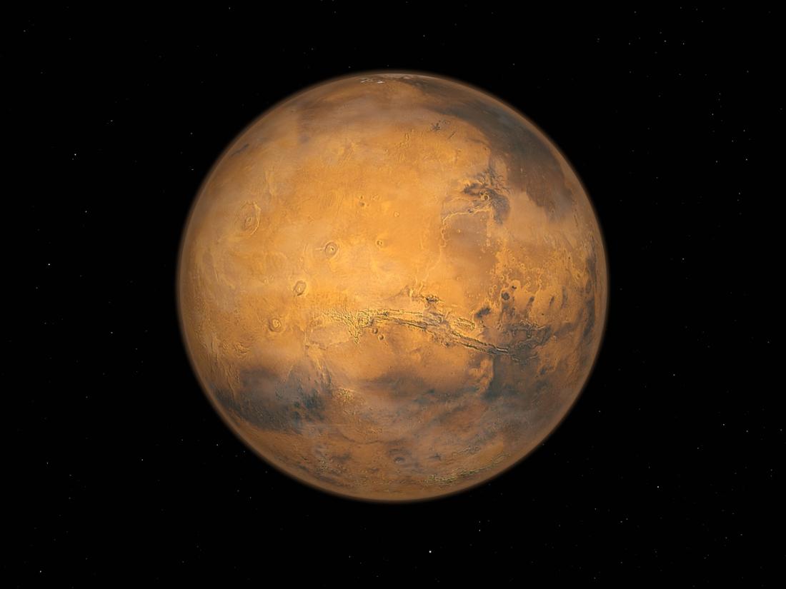 The red planet Mars.  The huge Valles Marineris rift system is clearly visible even from orbit.  Nearby is the newly discovered volcano.  (symbol image)