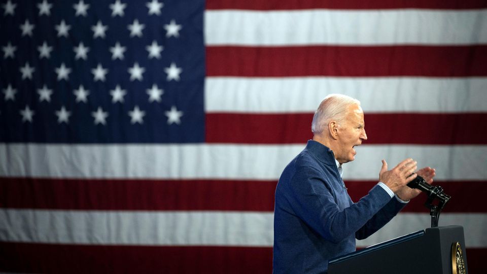 Joe Biden in front of a large US flag