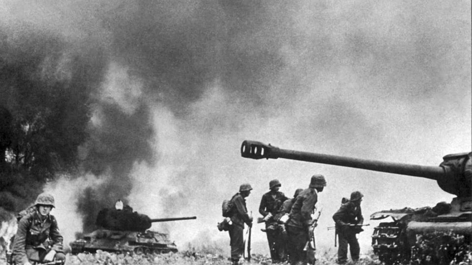 German troops amid Soviet tank wreckage.