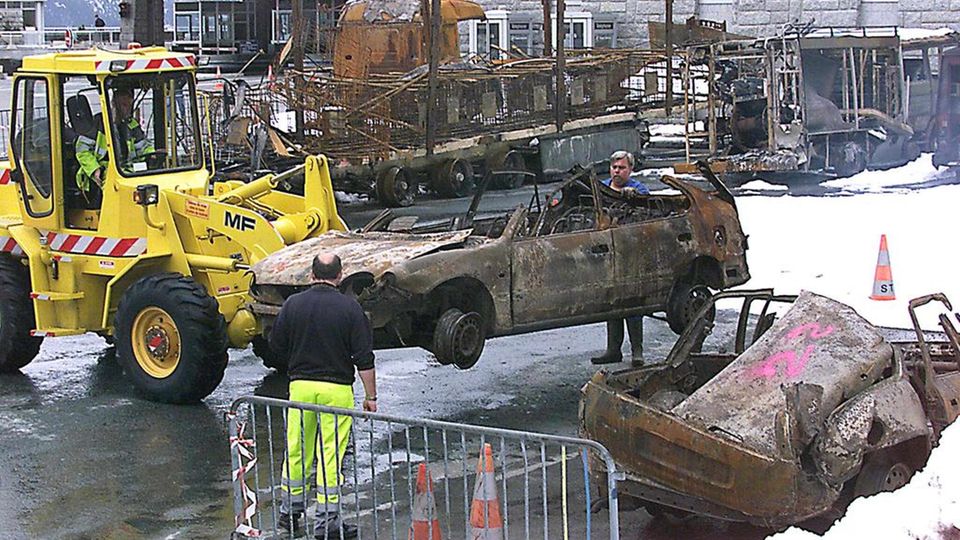 A burnt out car is recovered from the Mont Blanc Tunnel