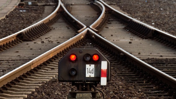 A railway signal lights up red in front of a switch.  © dpa-Bildfunk Photo: Julian Stratenschulte