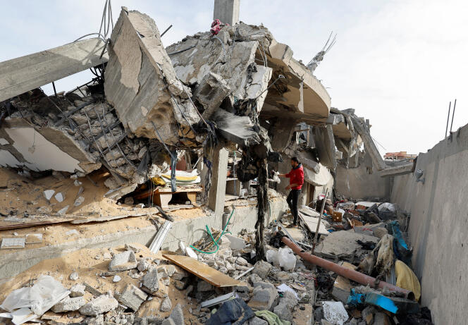 A Palestinian inspects the site of an Israeli strike on a house in Rafah, southern Gaza Strip, March 26, 2024.